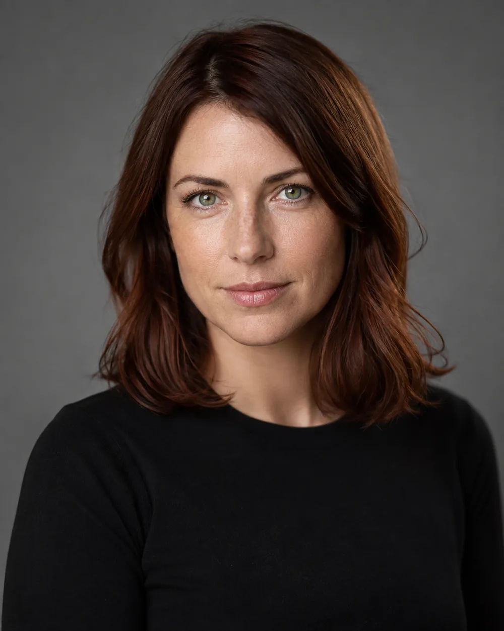 Studio portrait of an AI-generated model on a grey seamless backdrop